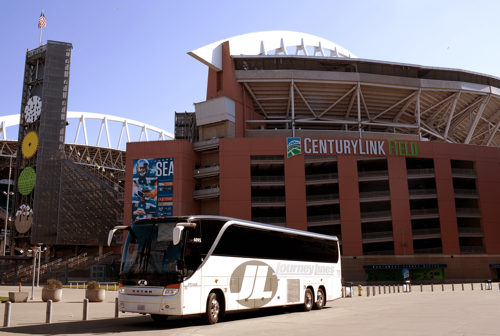 Journey Lines Charter Bus parked in front of CenturyLink Field Building