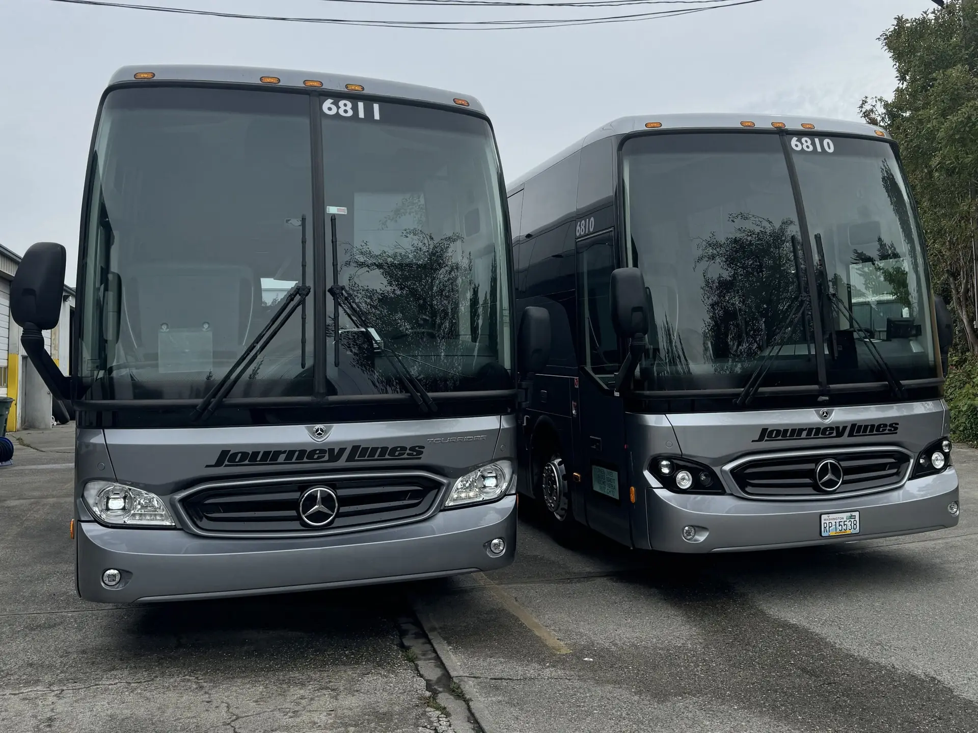 Two of our 56 passenger Mercedes-Benz Charter Buses, freshly cleaned and ready for their next adventure.